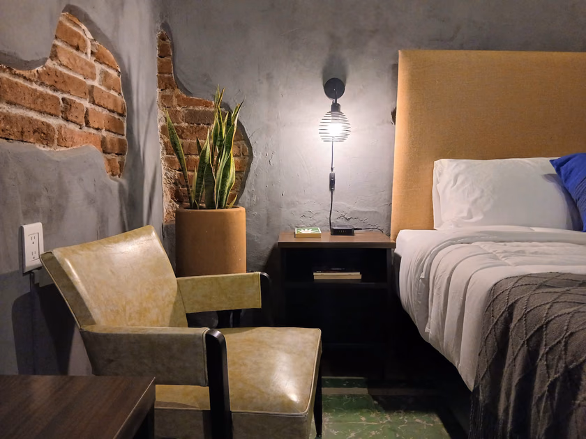 Recámara Sombra (sin ventana): Íntima y oscura que invita al descanso. Textiles suaves, pisos de pasta y una pieza artesanal con luna al centro evocan introspección profunda. Cada elemento crea un refugio sereno, perfecto para pausar y respirar.